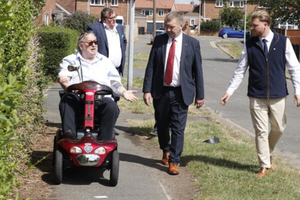 Cllr Bruce Wells, seated, talking to LCC Leader cllr Sean Matthews, Deputy Leader cllr Rob Gibson and county cllr Cain Parkinson about footpath issues in Grantham.