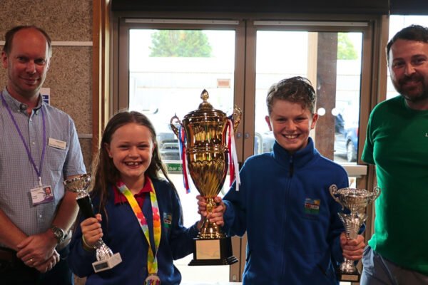 Cllr Paul Lock, executive support councillor for children’s services, presents the Recycling Olympics trophy to pupils from North Thoresby and Utterby Primary Academies at Lincolnshire County Council's first Environment Day